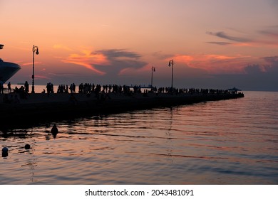 molo audace in Trieste with silhouette of many people at sunset . - Shutterstock ID 2043481091