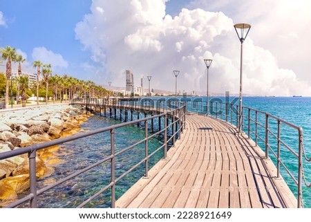 Molos Promenade in Limassol city in Cyprus . View of landmark with palm trees, pools of water, the Mediterranean sea