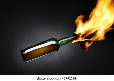 Molotov cocktail depicts flames shooting out of bottle filled with flammable liquid includes space for copy. - Shutterstock ID 87925144