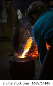 Molten Bronze Poured Into Mold By Melter In Foundry Workshop