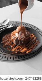 Molten Chocolate Lava Cake with molten chocolate dripping on ice cream from top of the cake.