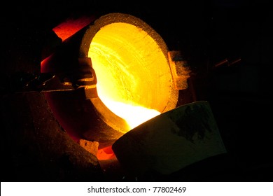  Molten Gold Being Poured From A Foundry Crucible