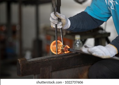 Molten hot glass on a metal rod for blowing or making shape process. - Powered by Shutterstock