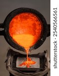 Molten metal being poured into a cast iron