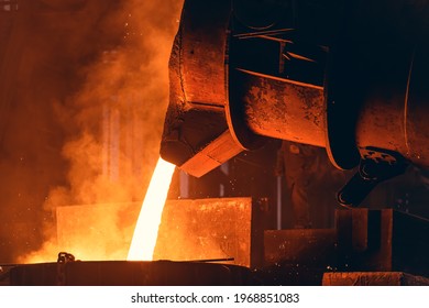 Molten Metal Pour From Big Container Into Sand Mold. Iron Casting In Metallurgy Foundry Plant, Heavy Industry