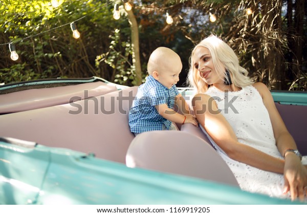 Mom and baby in the car. The concept of safe driving\
and a child car seat