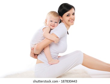 Mom And Baby Doing Exercise Home, Gymnastics, Yoga, Fitness And Health - Concept