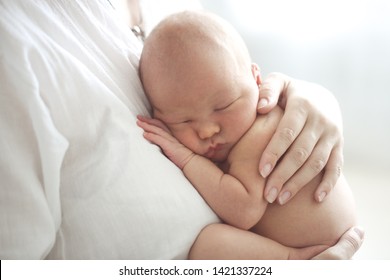 Mom And Baby, Newborn Mom In Her Arms. Light Photo In Casual Style In Real Interior, Close-up