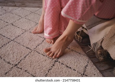 Mom And Baby In Pajamas. Bare Feet On The Carpet