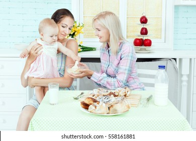 Mom And Baby Sitter Are Fed In The Kitchen.