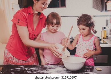 Mom Is Baking Cookies With Her Kids At Home Kitchen