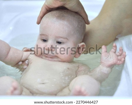 Similar – Newborn in the bathtub