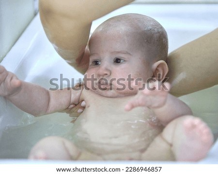 Similar – Newborn in the bathtub