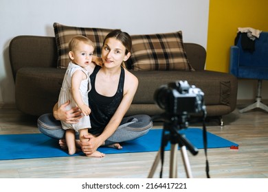 Mom Blogger Records Video On Camera With Her Little Daughter At Home.