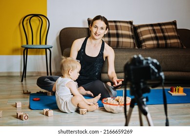 Mom Blogger Records Video On Camera With Her Little Daughter At Home.