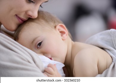 Mom breast feeding baby girl