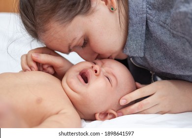 Mom Calms Crying Newborn Baby Who Has Tummy Ache, Selective Focus