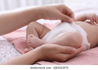 Mom Changing Baby's Diaper On Bed At Home, Closeup