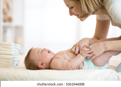 Mom Changing A Diaper On Newborn Baby