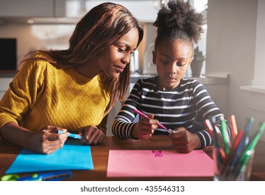 Mom And Child Drawing In Kitchen, Black Mother And Daughter