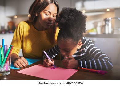 Mom And Child Drawing In Kitchen, Black Mother And Daughter