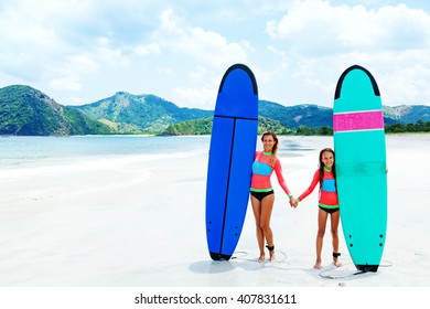 Mom with child are learning surfing together - Powered by Shutterstock