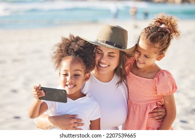 Mom, Children And Beach With Phone For Selfie In The Sunshine While On Holiday Together. Mother, Kids And Ocean Take Photo With Smartphone In The Sun On Vacation Or Family Travel To The Sea