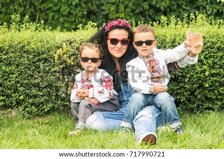 Mom and children dressed in national costumes of Ukraine.