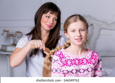 Mom Combing Hair Of His Daughter