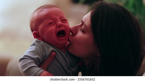 Mom consoling crying newborn baby