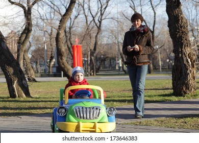 Mom Controls The Car With Her Son Using Remote Control