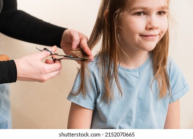 Mom Cuts Her Daughter's Wet Hair. Cutting Hair At Home. Life Hacks And Rules Of Hair Care. Special Combs And Scissors For Hairdressers.