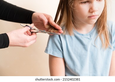 Mom Cuts Her Daughter's Wet Hair. Cutting Hair At Home. Life Hacks And Rules Of Hair Care. Special Combs And Scissors For Hairdressers.