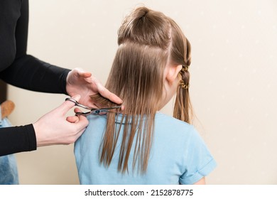 Mom Cuts Her Daughter's Wet Hair. Cutting Hair At Home. Life Hacks And Rules Of Hair Care. Special Combs And Scissors For Hairdressers.