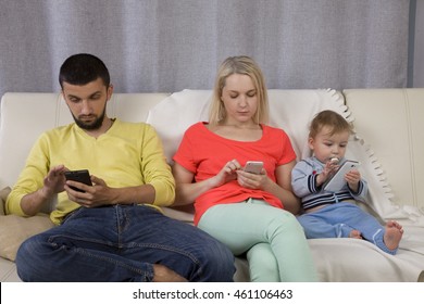 Mom, Dad And Baby Looking Phones. Digital Addiction. Digital Dementia