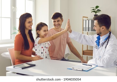 Mom, Dad And Child Seeing Family Practitioner. Happy Girl High-fiving Her Pediatrician. Concept Of Healthcare For Children, Visit To Hospital, Little Patients' Trust And Positive Attitude To Doctors