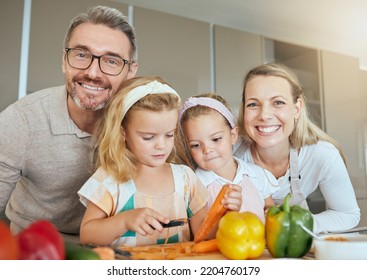 Mom, Dad And Children In The Kitchen, Cooking Together And Learning. Portrait Of Family At Home Teaching Kids How To Cook, Cut Vegetables And Prepare Food. Child Development, Educate And Life Skills