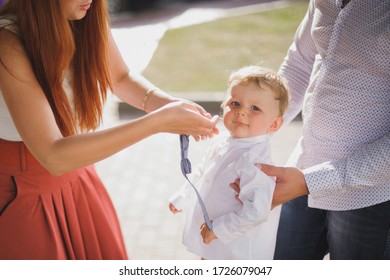 Mom And Dad Dress Up Their Son On The Street