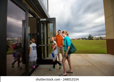 Mom And Dad At The Gym Door Taking The Kids To Their Basketball Game