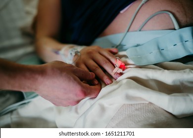 Mom and Dad labor together during hard hospital birth in hospital bed - Powered by Shutterstock