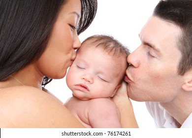 A Mom And Dad Parent Kissing Their Young Baby