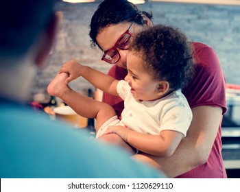 Mom And Dad Playing With Little Girl