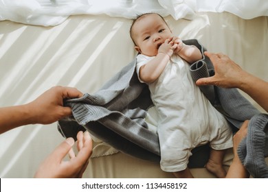 Mom And Dad Are Taking Care Of Their Baby Changing His Diaper