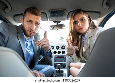 Mom And Dad Turning Back And Making Angry Faces As They Are Being Upset By The Behavior Of Their Kids In The Back Seat