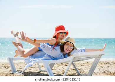 Mom And Daughter At Beach Chaise Lounge