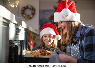 Mom And Daughter Are Cooking  The Christmas Goose Together At Home 