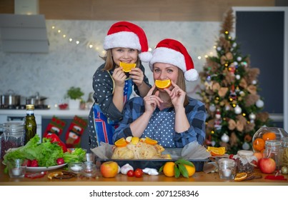 Mom And Daughter Are Cooking  The Christmas Goose Together At Home 