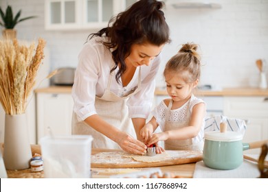 Mom And Daughter Are Cooking In The Kitchen Of A Country House