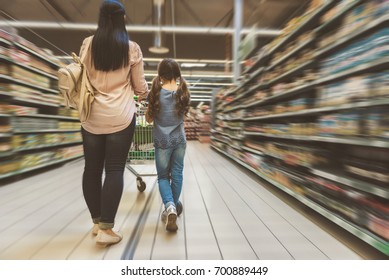 Mom And Daughter Doing Shopping