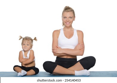 Mom And Daughter Engage In Fitness On Blue Mat